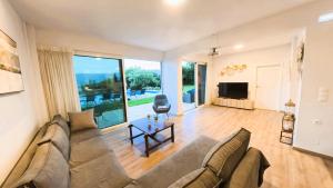 a large living room with a couch and a table at MG Residence Boutique Holiday Home in Korakiaí