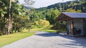 a gravel driveway leading to a small building with a gazebo at Casa Primavera in Pomerode