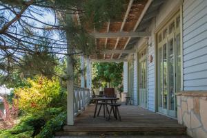 a porch of a house with a table on it at Delta Resort Treetop by Eight Continents in Tulcea