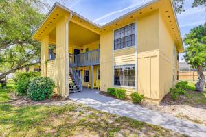 a large yellow building with a staircase in front at Walk to St Augustine Beach! Condo w/ Pool Access in Saint Augustine Beach
