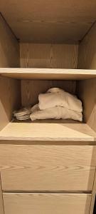 a closet with two white pillows on a shelf at Dreamland Oasis 14-704 apartment in Chakvi