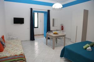 a living room with a table and a room with a bed at SEAINSIDE HOUSE - PENISOLA SORRENTINA in Piano di Sorrento