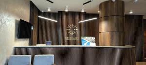 a lobby with a counter with chairs and a clock at Dream Land Oasis 14-704 apartment in Chakvi +56 photos
