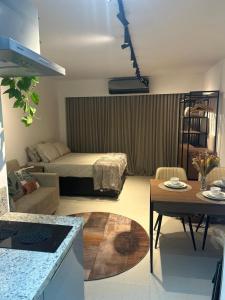 a living room with a bed and a table at SkyLux Rio Luxo com Garagem in Rio de Janeiro