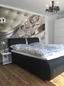 a bedroom with a bed with a black bed frame at Enjoyit-WS in Velden am Wörthersee