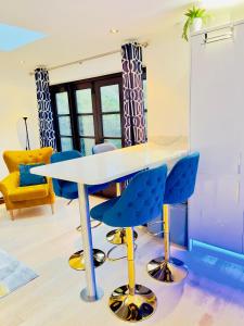 a meeting room with a table and blue chairs at Fairy Meadows Hideaway in Peterborough