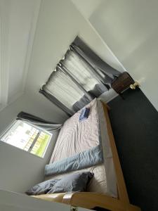 a small room with a bed and a window at 3 Bedroom serviced House A, 9 Steeles Lane in Rotorua