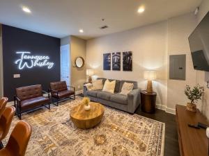 a living room with a couch and a table at The Tennessee Whiskey in West End-Vandy- Uber to Broadway in Nashville