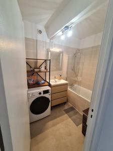 a bathroom with a sink and a washer at Belle appartement cocooning Proche Paris et Aéroport Charles de Gaulle in Livry-Gargan