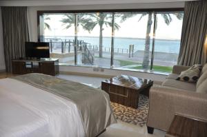 A bed or beds in a room at Tio Sea Resort
