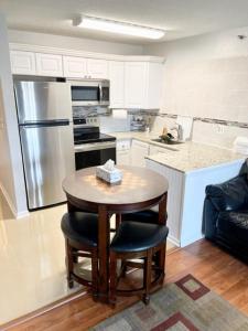 a kitchen with a small table and a refrigerator at 300 ROBIN DR Walking Distance to Beach in Ocean City