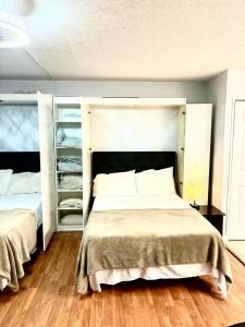 a bedroom with a large bed and shelves at 300 ROBIN DR Walking Distance to Beach in Ocean City