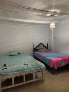 En eller flere senge i et værelse på Casa de Campo Mamaia