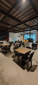 a group of tables and chairs in a restaurant at Hostal Bryan in Tacna +36 photos