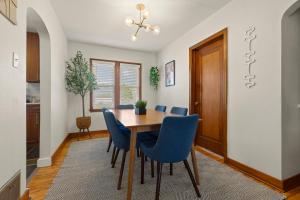 a dining room with a table and blue chairs at The Gilded Cottage Entire Home in Winnebago +10 photos