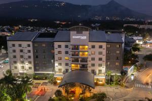 a large building in a city at night at Courtyard by Marriott San Salvador in San Salvador +36 photos
