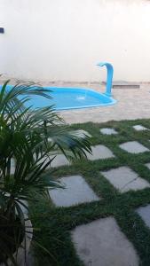 a blue swimming pool with a fountain in the water at Francisco das Chagas Andrade in Martins
