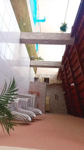 a hallway of a building with stairs and plants at Francisco das Chagas Andrade in Martins