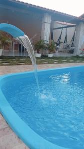 a water fountain in a swimming pool at Francisco das Chagas Andrade in Martins