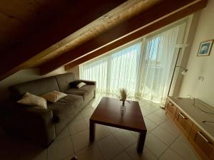 a living room with a couch and a table at Jesolo attic - beach spot in Lido di Jesolo +80 photos