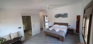 a bedroom with a bed and a couch in it at Costabravasuites Villa Los Vientos in Calella de Palafrugell