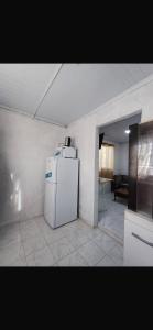 a kitchen with a white refrigerator in a room at Apartment in an excellent location in Colonia del Sacramento