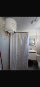 a bathroom with a shower curtain and a sink at Apartment in an excellent location in Colonia del Sacramento