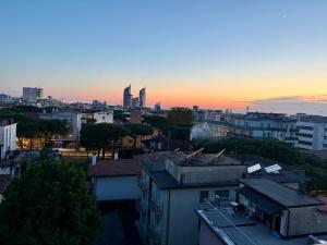 a view of a city skyline at sunset at Jesolo attic - beach spot in Lido di Jesolo