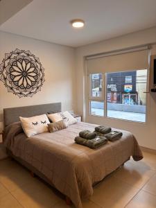 Un dormitorio con una cama grande con una ventana grande. en Departamento Austral II, en Ushuaia