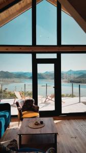 a living room with a view of the water at Above the Lake in Rogani
