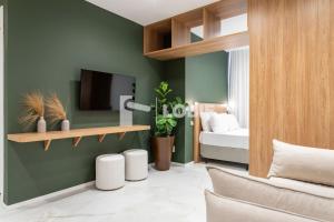 a living room with a couch and a tv on a wall at Lobie Dias Downtown in Rio de Janeiro +64 photos