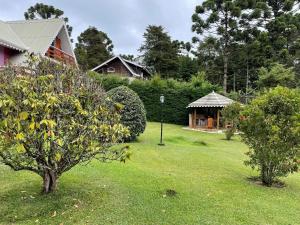 a yard with a gazebo and a house at o sossego e aqui in Campos do Jordão