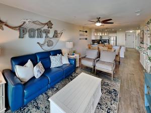 a living room with a blue couch at Shore Thang in Port Aransas