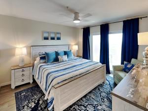 a bedroom with a large bed and a couch at Shore Thang in Port Aransas +11 photos