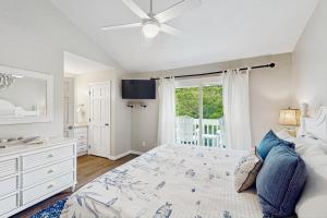 a bedroom with a bed and a ceiling fan at Ocean Glen 12 in Pine Knoll Shores