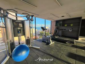 a room with a gym with a view of the city at Emunah-Ponta de Campina Cabedelo in Cabedelo