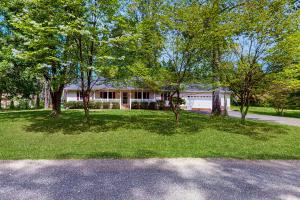 a house with trees in front of a yard at Good Time Charli's in Glenora
