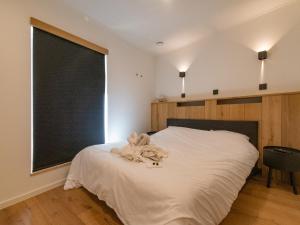 a bedroom with a bed with a chalkboard on the wall at Holiday Home in La Roche with Castle Views in La Roche-en-Ardenne +21 photos