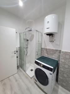 a bathroom with a microwave and a shower at Muzien B&B in Imola +9 photos