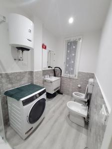 a bathroom with a toilet and a sink at Muzien B&B in Imola