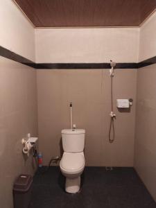 a bathroom with a toilet and a shower at Mikha Homestay BUNAKEN in Manado +25 photos