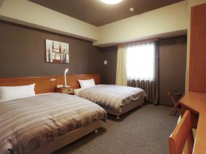 Ένα ή περισσότερα κρεβάτια σε δωμάτιο στο Hotel Route-Inn Hamanako +26 φωτογραφίες