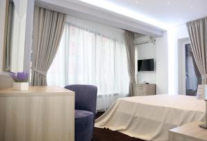 a hotel room with a bed and a window at Parliament Square in Bucharest