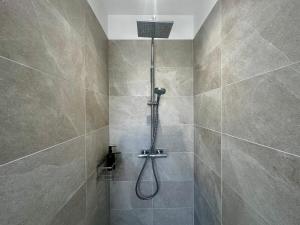 a shower with a shower head in a bathroom at Renovated villa with terrace, 750m to beach in Saint-Georges-de-Didonne +25 photos