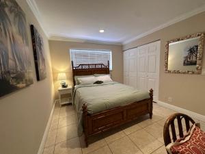a bedroom with a bed and a window at Downtown Boca Apt in Boca Raton