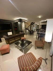 a living room with couches and chairs and a table at Hotel Aires de Tandil in Tandil +20 photos