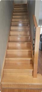 a stairway with wooden steps in a house at A Cosy Corner in Melbourne