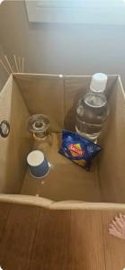 a box with a bag of chips and a bottle of water at A Cosy Corner in Melbourne
