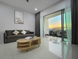 a living room with a couch and a table at Ezyhouz # Luxury 3Bedroom Seaview Balcony IMAGO TheLoftB KotaKInabalu CIty10Pax in Kota Kinabalu