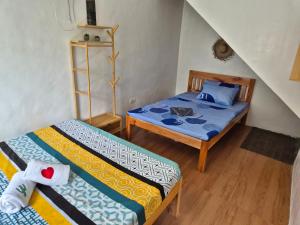 a bedroom with two beds and a staircase at Amazing Ocean View Treehouse & Pool in Puerto Princesa City